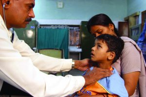 A doctor checks a child for symptoms of TB © Gary Hampton